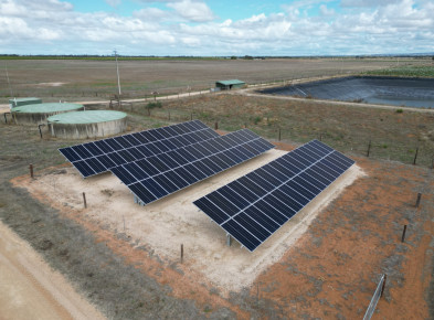 A set of solar panels alongside a water reservoir